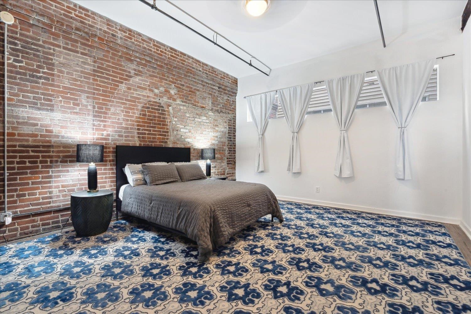 413 South Main Street, Unit 206 Memphis, TN 38103 - Photo 13 of 23 a spacious bedroom with a bed and a window