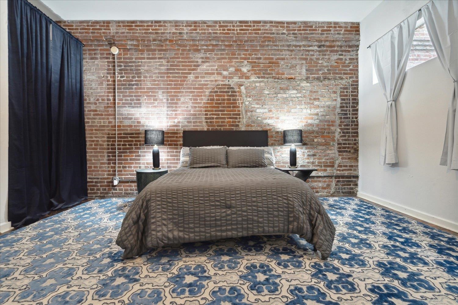 413 South Main Street, Unit 206 Memphis, TN 38103 - Photo 14 of 23 a bedroom with a bed and a window