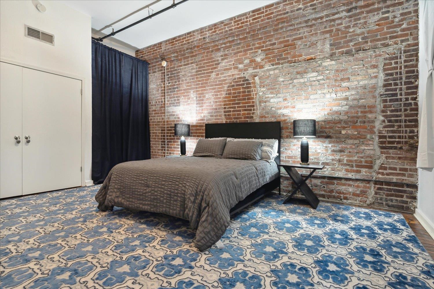 413 South Main Street, Unit 206 Memphis, TN 38103 - Photo 15 of 23 a spacious bedroom with a bed and a window