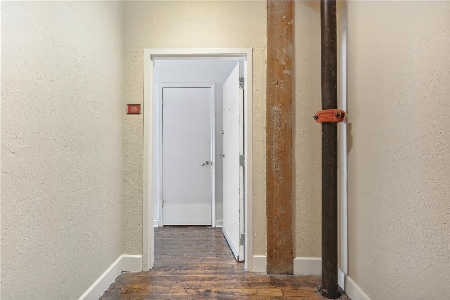 413 South Main Street, Unit 206 Memphis, TN 38103 - Photo 16 of 23 a view of a hallway with wooden floor