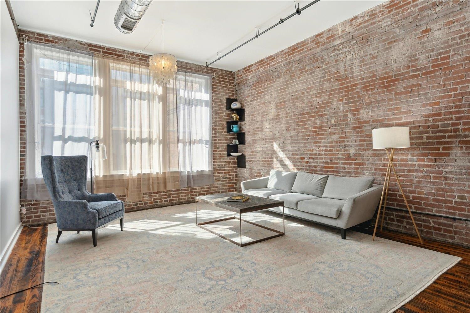 413 South Main Street, Unit 206 Memphis, TN 38103 - Photo 3 of 23 a living room with furniture and a floor to ceiling window