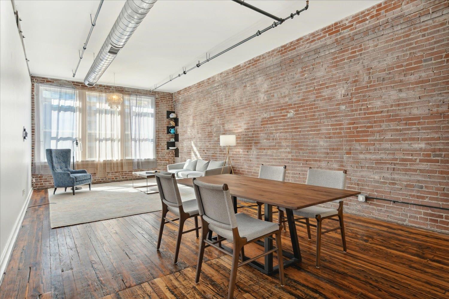 413 South Main Street, Unit 206 Memphis, TN 38103 - Photo 6 of 23 a view of a dining room with furniture and wooden floor