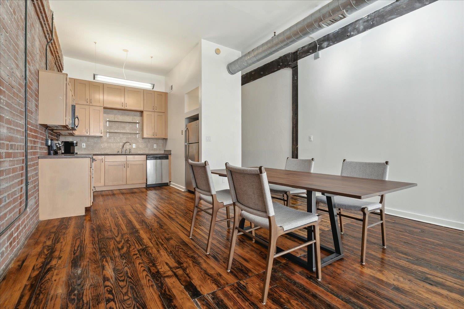 413 South Main Street, Unit 206 Memphis, TN 38103 - Photo 7 of 23 a view of a dining room with furniture and wooden floor