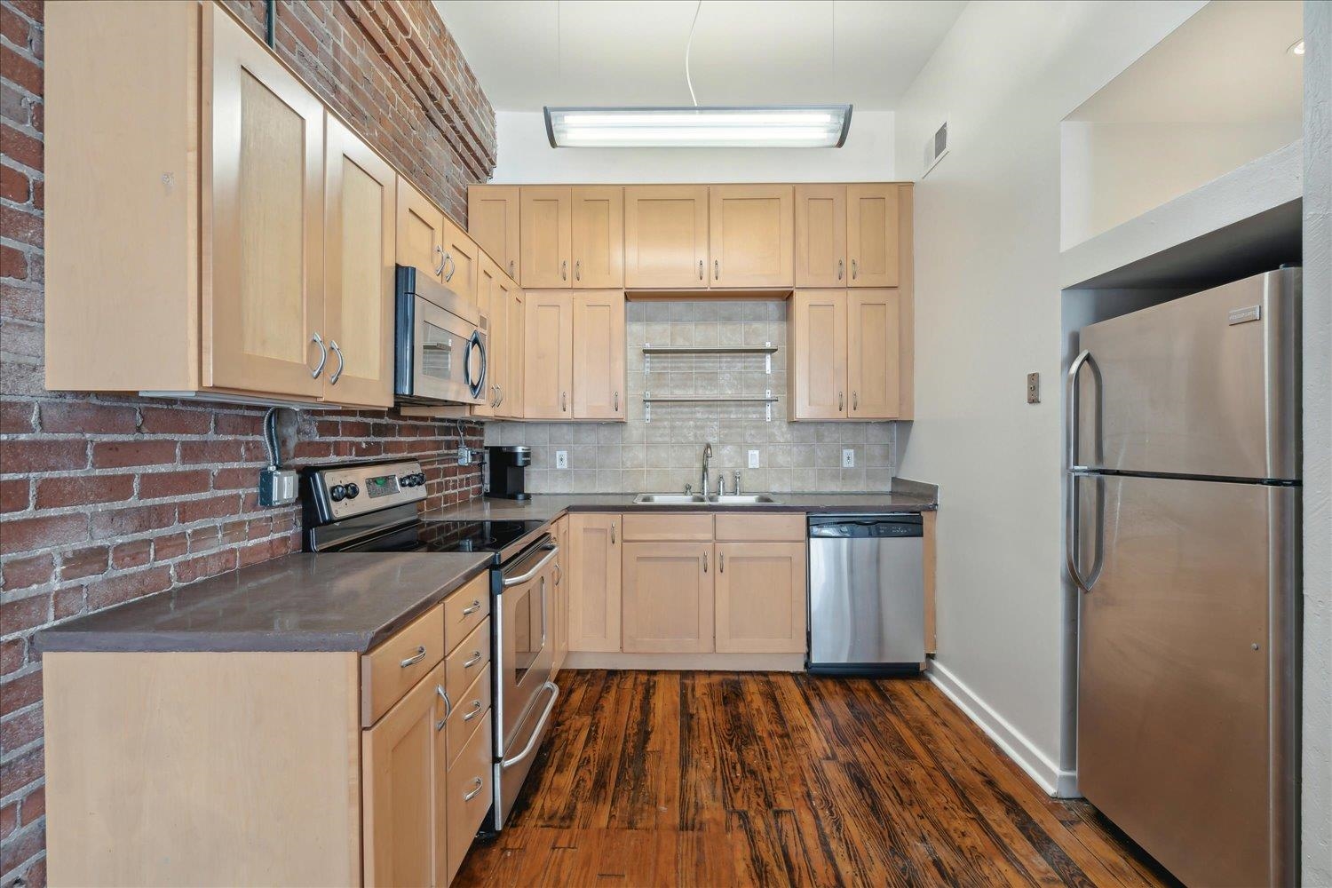 413 South Main Street, Unit 206 Memphis, TN 38103 - Photo 8 of 23 a kitchen with a refrigerator sink and cabinets