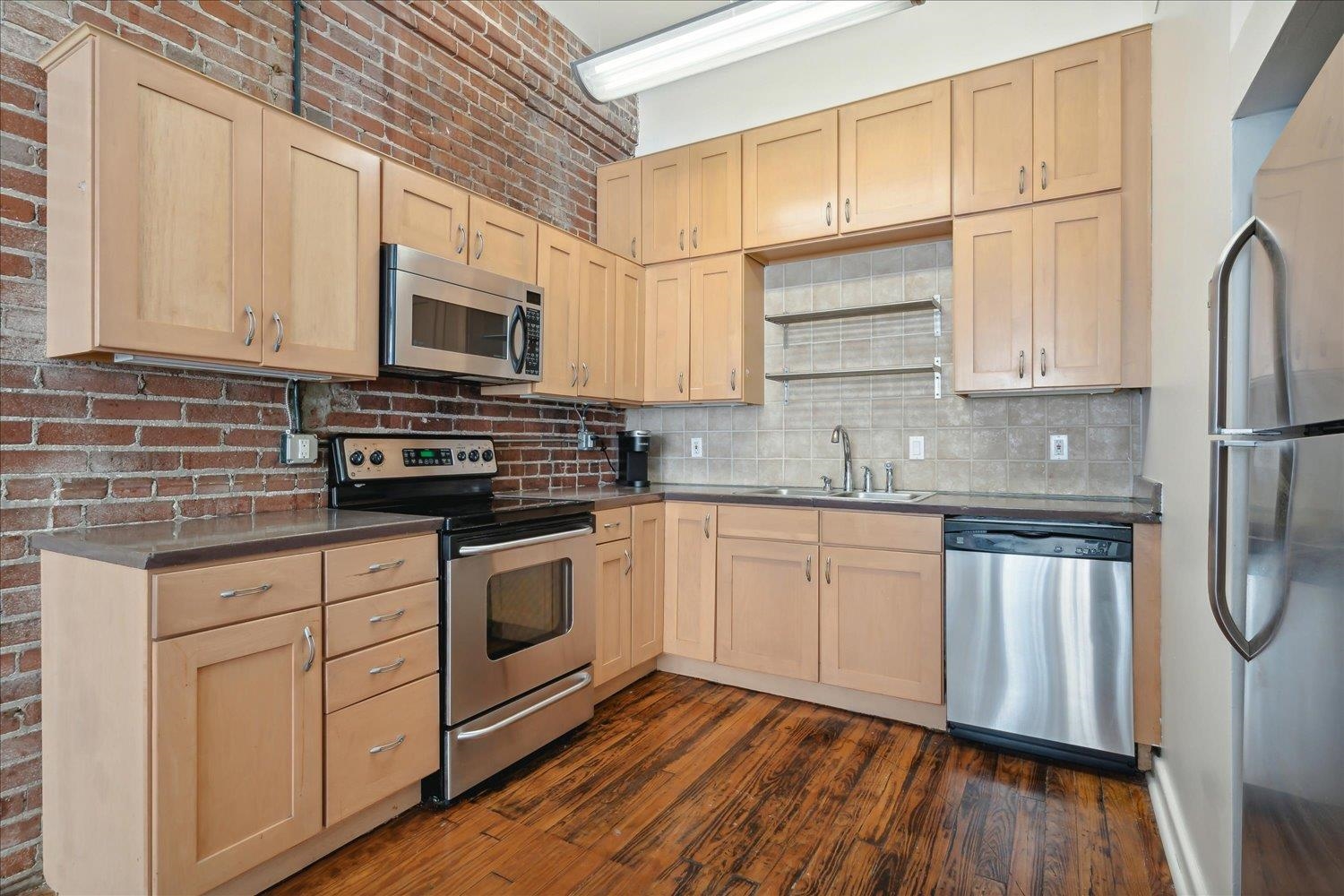 413 South Main Street, Unit 206 Memphis, TN 38103 - Photo 9 of 23 a kitchen with stainless steel appliances granite countertop a stove a sink and white cabinets