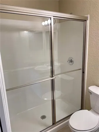 a bathroom with a shower and a toilet