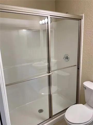 a bathroom with a shower and a toilet