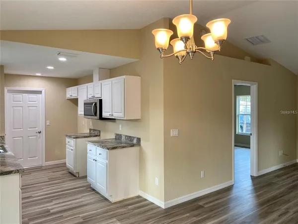 a view of a kitchen counter space and wooden floor