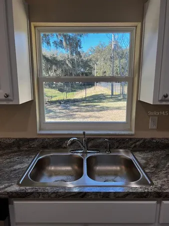 a kitchen sink sitting next to a window