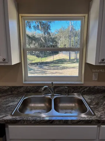 a kitchen sink sitting next to a window