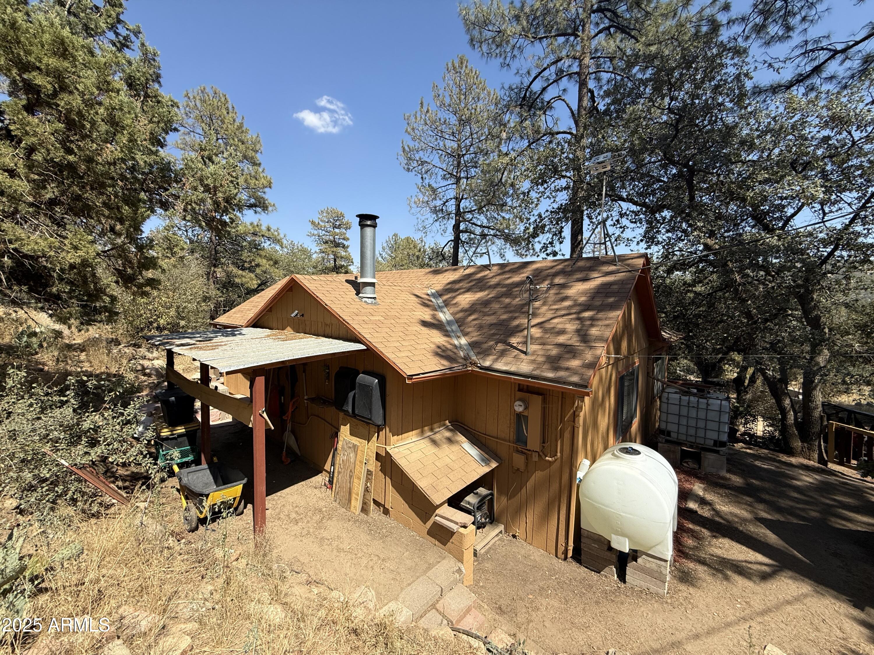 23576 Sunny South Road Crown King, AZ 86343 - Photo 11 of 29 a view of a patio with table and chairs with wooden fence and plants