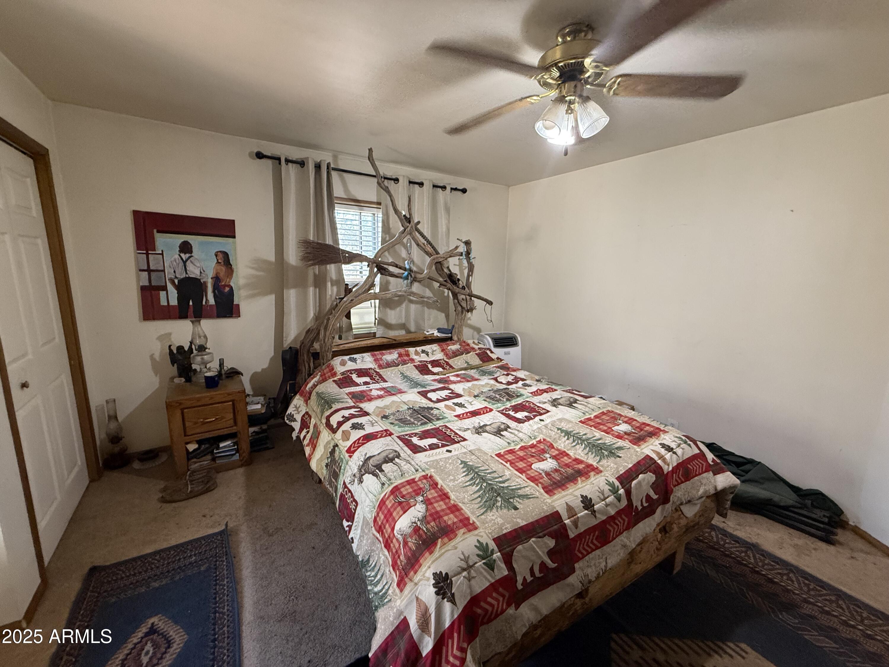 23576 Sunny South Road Crown King, AZ 86343 - Photo 2 of 29 a bedroom with a bed and a chandelier