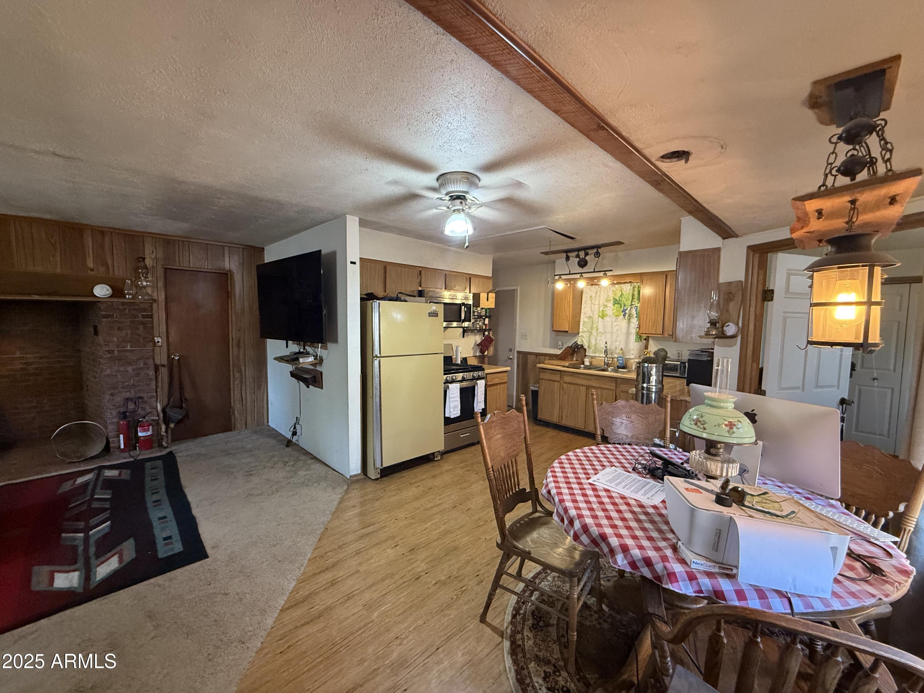 23576 Sunny South Road Crown King, AZ 86343 - Photo 29 of 29 a view of a dining room with furniture a kitchen and chandelier