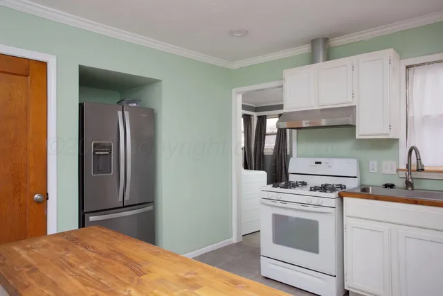 a kitchen with a stove and a refrigerator