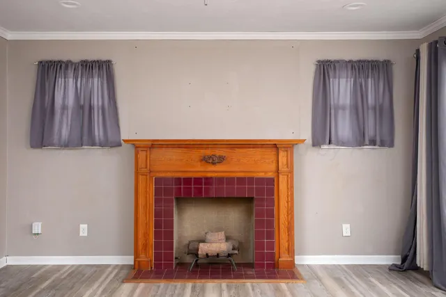 a hallway with a fireplace and a wooden floor