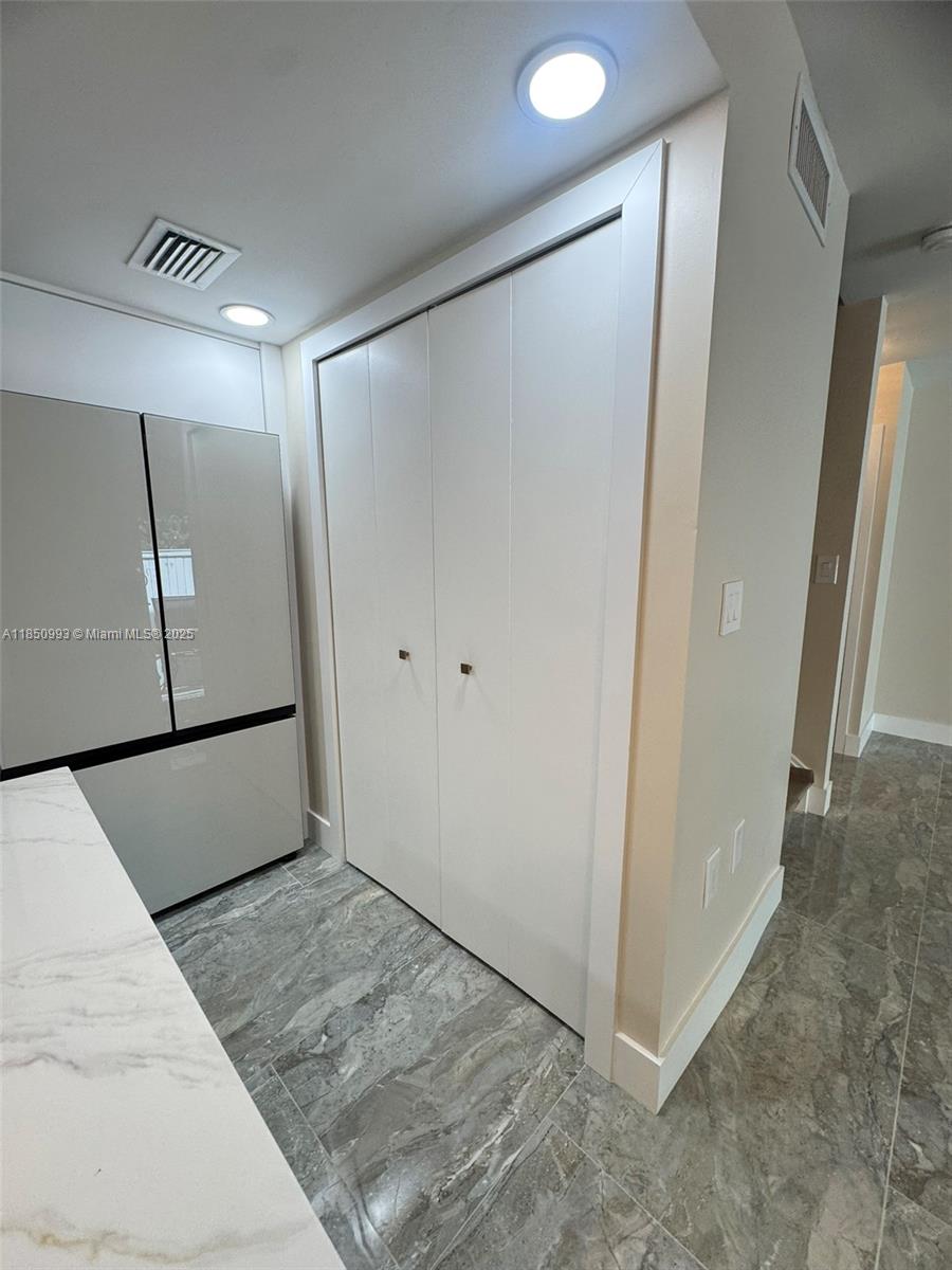 4520 Southwest 68th Ct Circle, Unit 305 Miami, FL 33155 - Photo 11 of 46 a view of a hallway with wooden floor