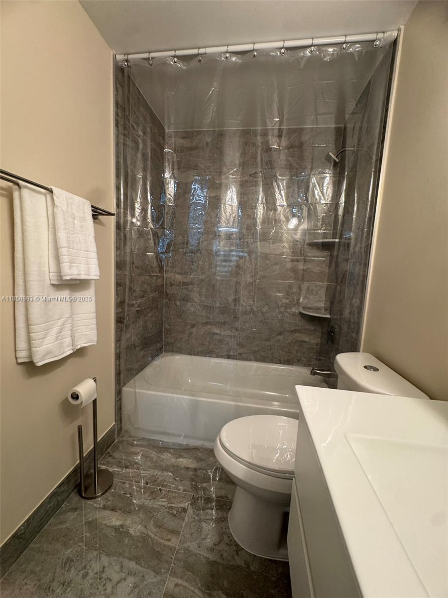 4520 Southwest 68th Ct Circle, Unit 305 Miami, FL 33155 - Photo 31 of 46 a bathroom with a bathtub and a shower