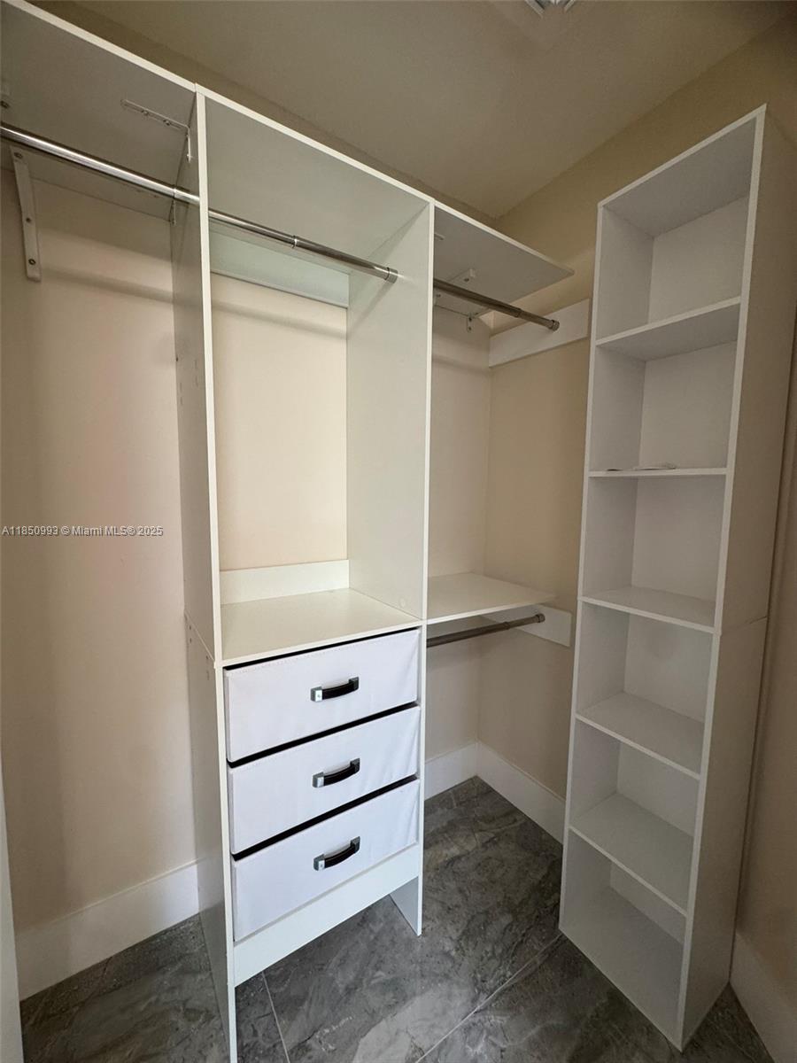 4520 Southwest 68th Ct Circle, Unit 305 Miami, FL 33155 - Photo 41 of 46 a view of an empty walk in closet