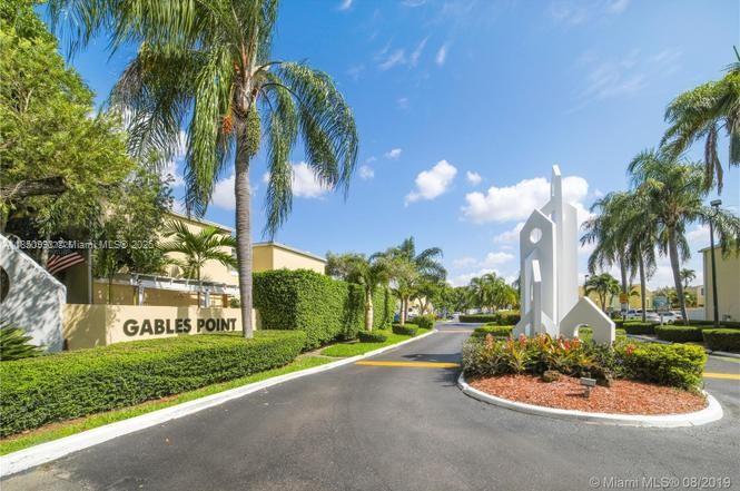 4520 Southwest 68th Ct Circle, Unit 305 Miami, FL 33155 - Photo 46 of 46 a front view of a house with a yard and garage