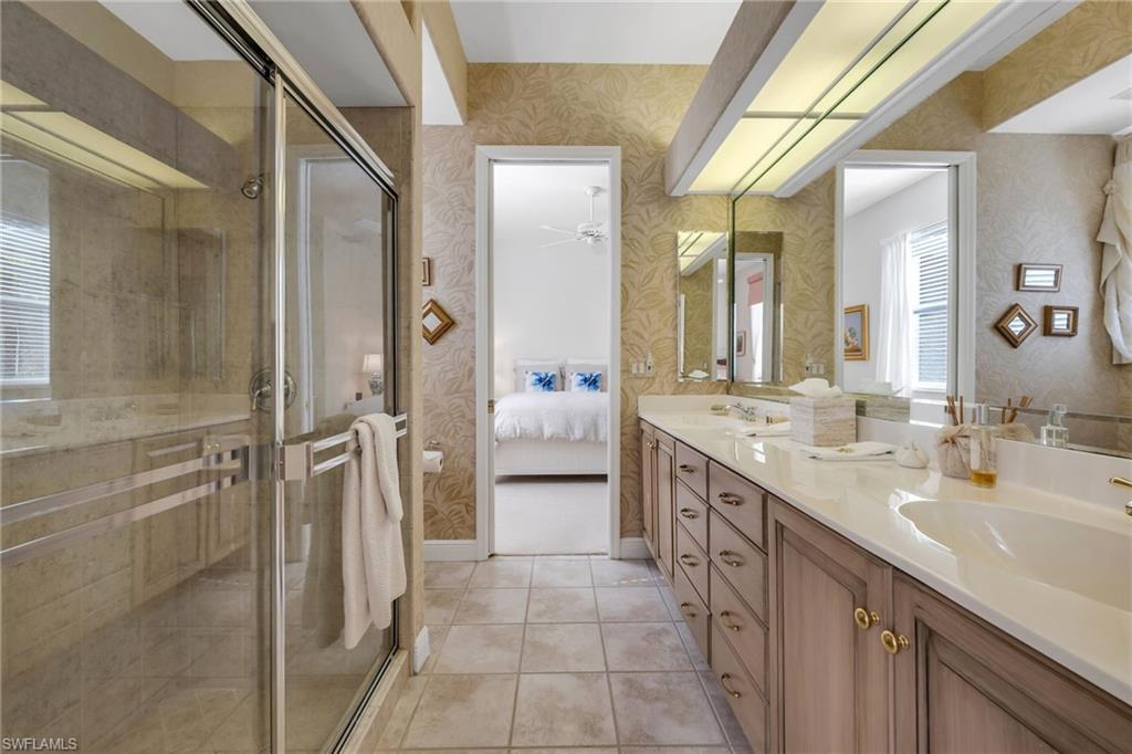 20001 Chapel Trace Estero, FL 33928 - Photo 15 of 32 a spacious bathroom with a double vanity sink mirror and shower