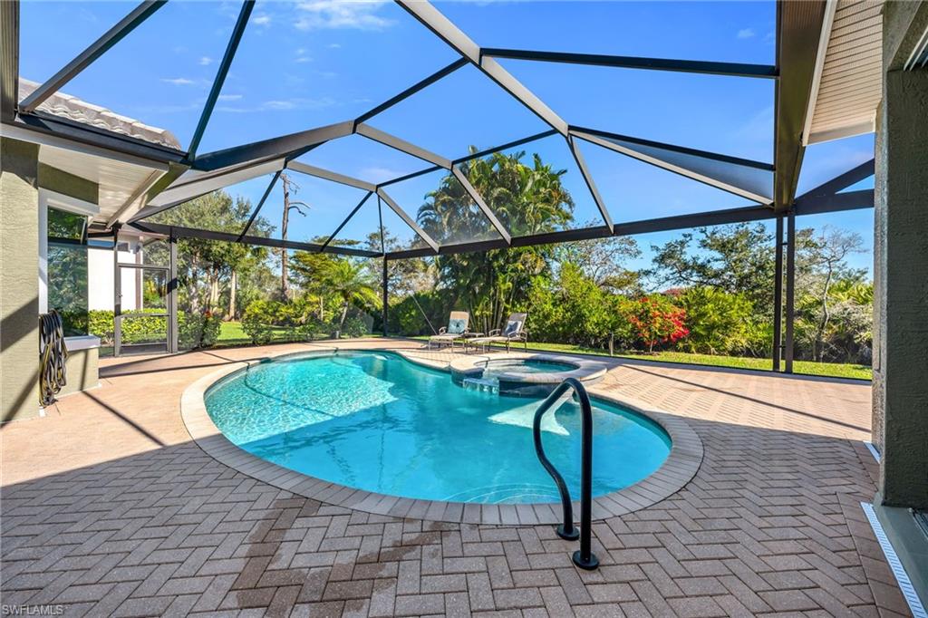 20001 Chapel Trace Estero, FL 33928 - Photo 22 of 32 a view of a swimming pool with a patio