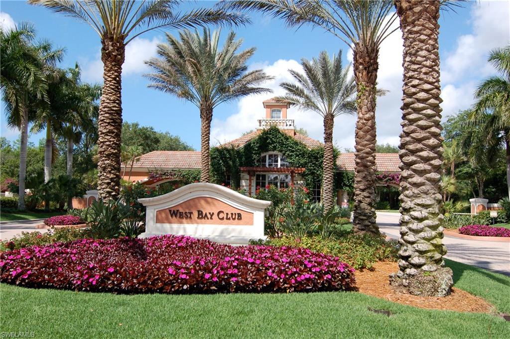 20001 Chapel Trace Estero, FL 33928 - Photo 23 of 32 a front view of multi story residential apartment building with yard and sign board