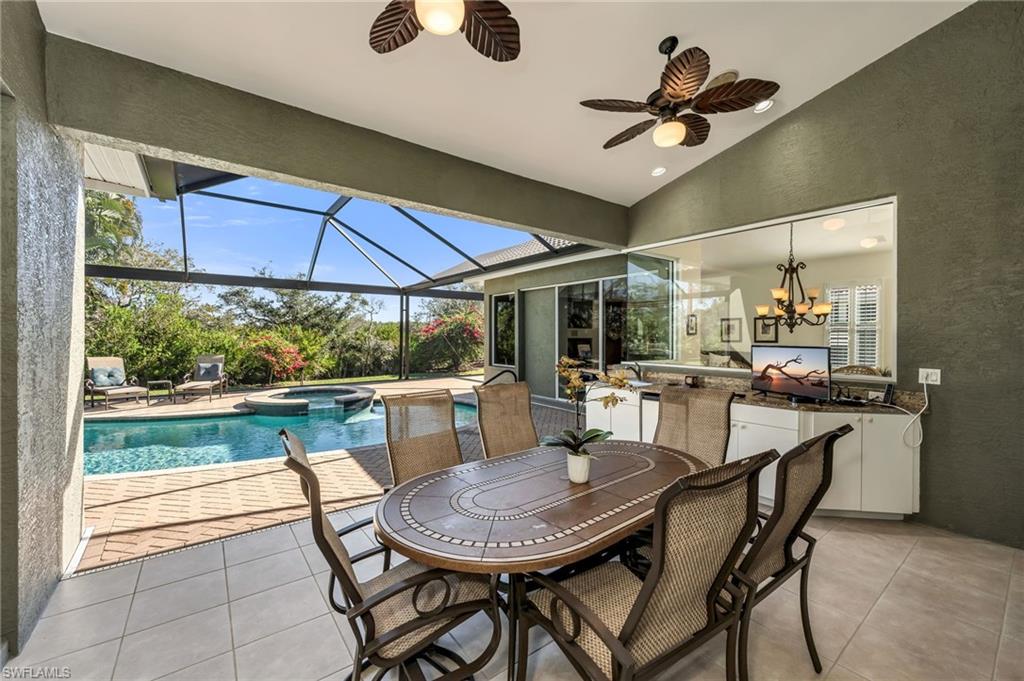 20001 Chapel Trace Estero, FL 33928 - Photo 10 of 32 a dining room with furniture a floor to ceiling window and a ceiling fan