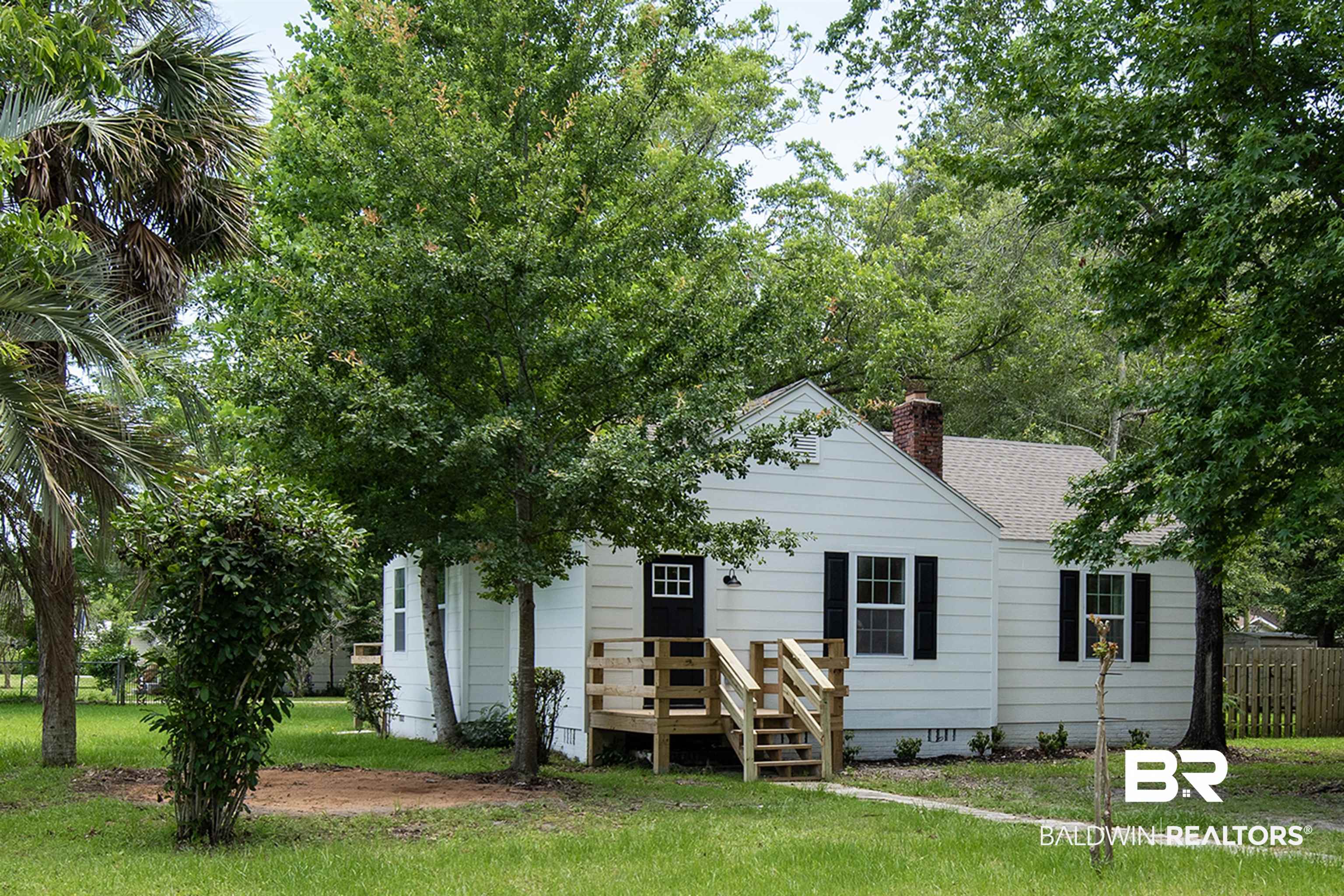 510 East Myrtle Avenue Foley, AL 36535 - Photo 1 of 22 View of front of house with roof with shingles and a chimney