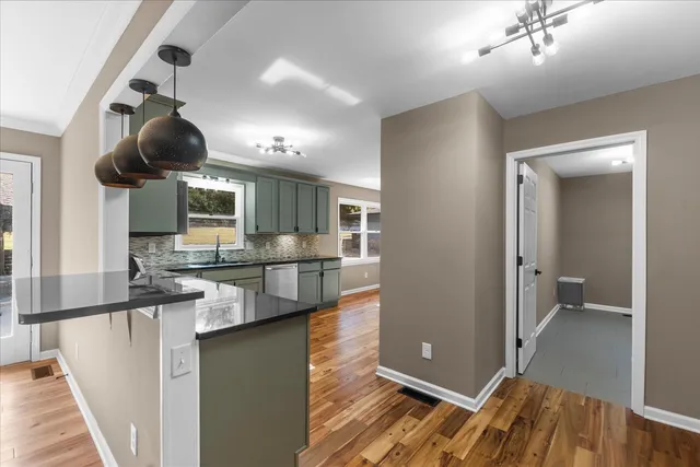 a kitchen with stainless steel appliances kitchen island granite countertop a sink and cabinets
