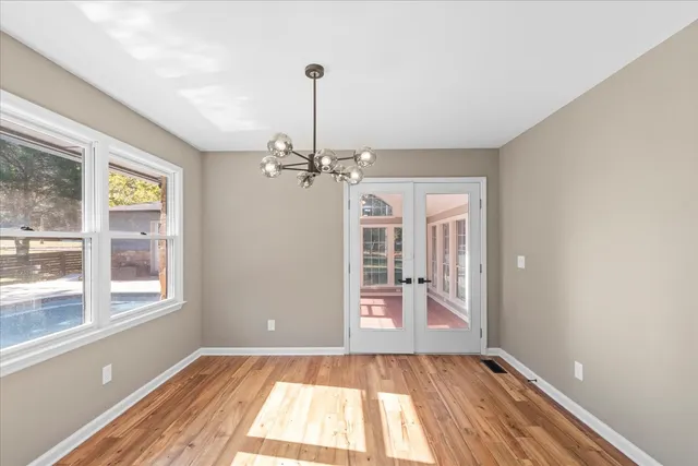 a view of an empty room with windows