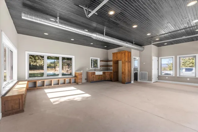 a view of a house with swimming pool and sitting area