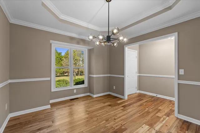 a view of a room with wooden floor closet and windows