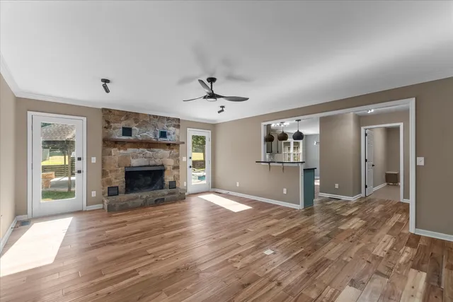 a view of an empty room with a fireplace and a window