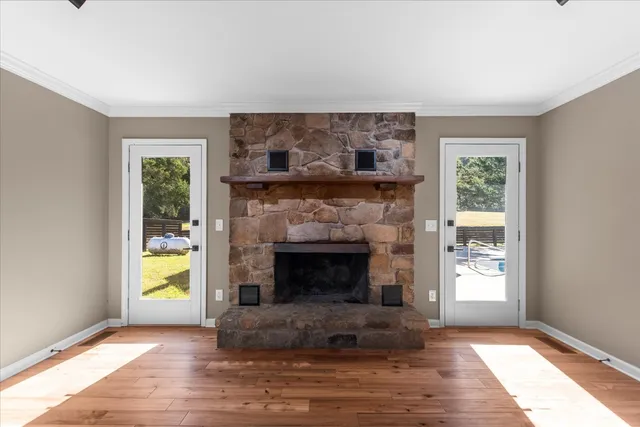 a living room with a fireplace and a large window
