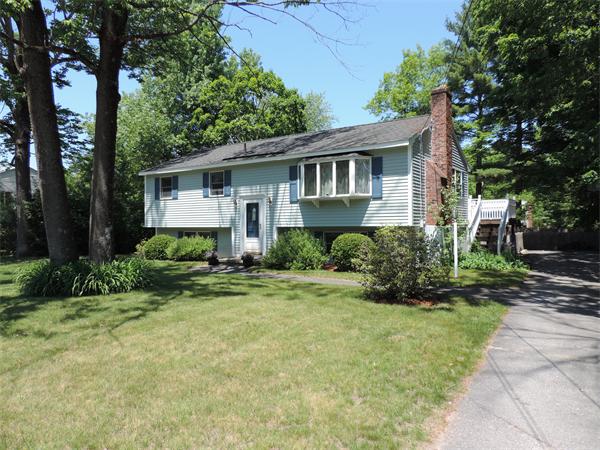 7 Haskell Road Pepperell, MA 01463 - Photo 1 of 25 a front view of a house with a yard and trees