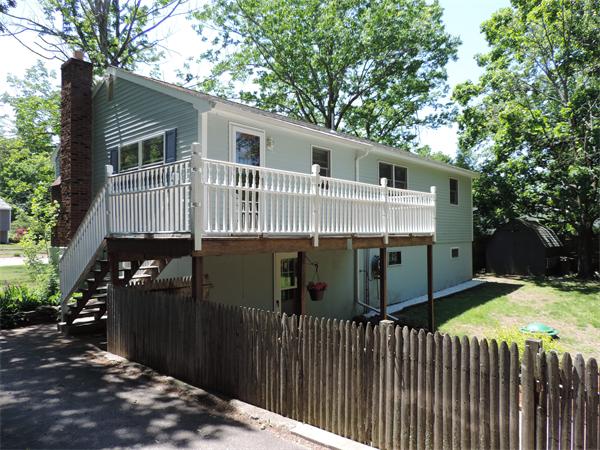 7 Haskell Road Pepperell, MA 01463 - Photo 23 of 25 a view of a small house with wooden fence
