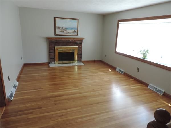 7 Haskell Road Pepperell, MA 01463 - Photo 4 of 25 a view of an empty room with a window and fireplace