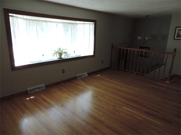 7 Haskell Road Pepperell, MA 01463 - Photo 5 of 25 a view of an empty room with wooden floor and a window