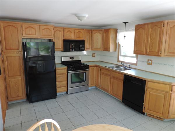 7 Haskell Road Pepperell, MA 01463 - Photo 6 of 25 a kitchen with stainless steel appliances granite countertop a stove a sink dishwasher and a refrigerator
