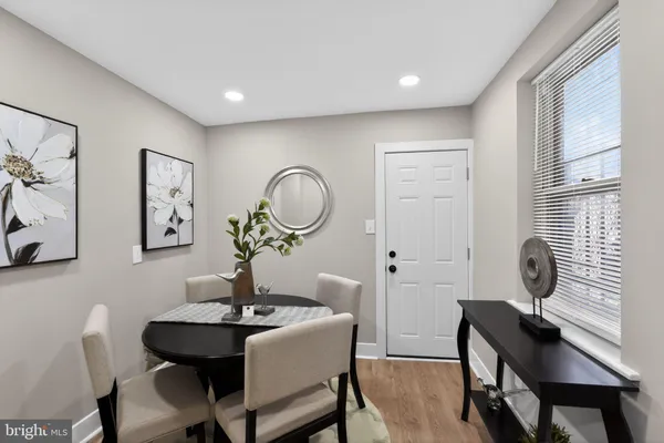 a view of a dining room with furniture and a mirror