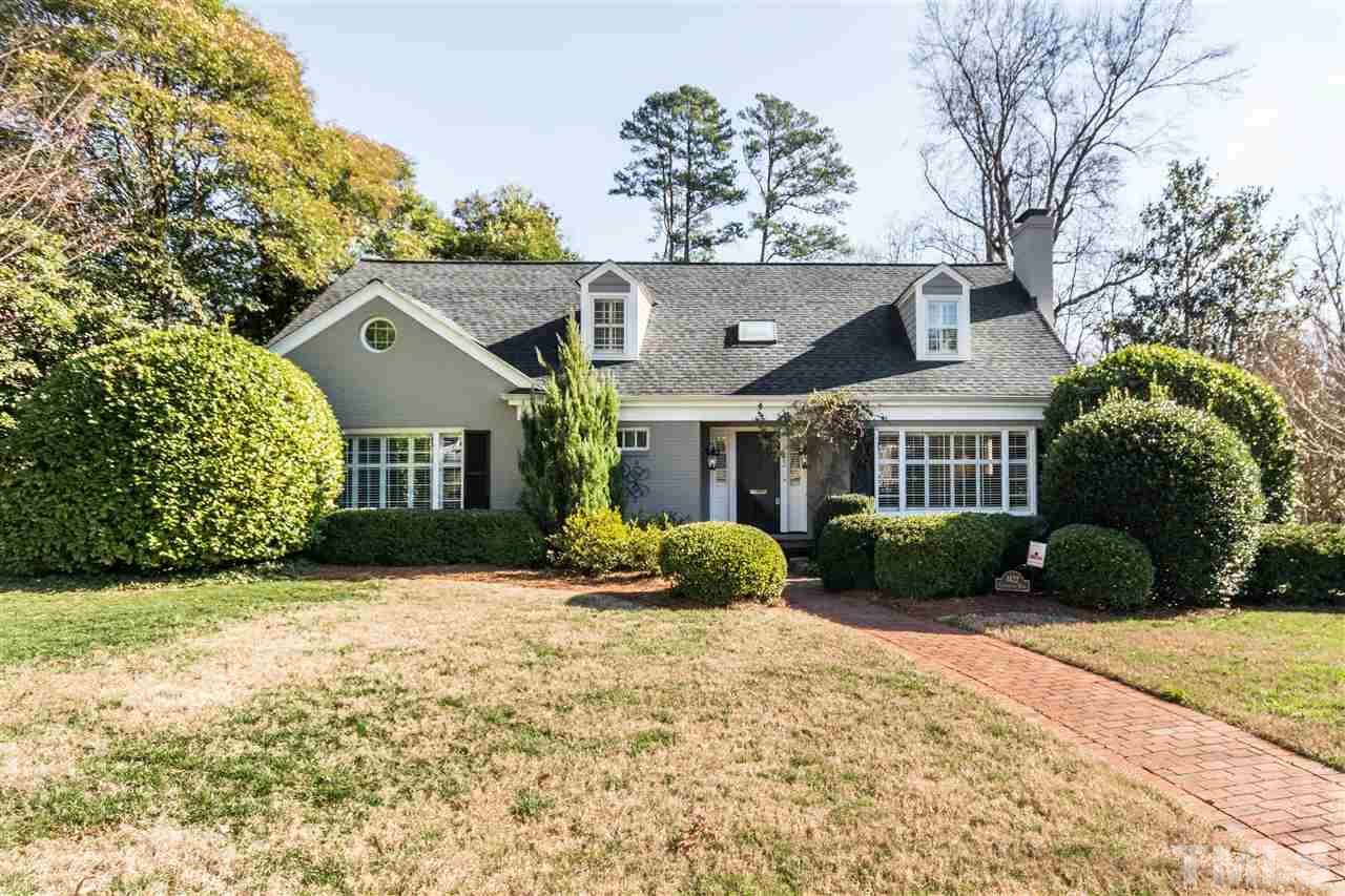 1422 Canterbury Road Raleigh, NC 27608 - Photo 1 of 25 a front view of a house with a yard and garage