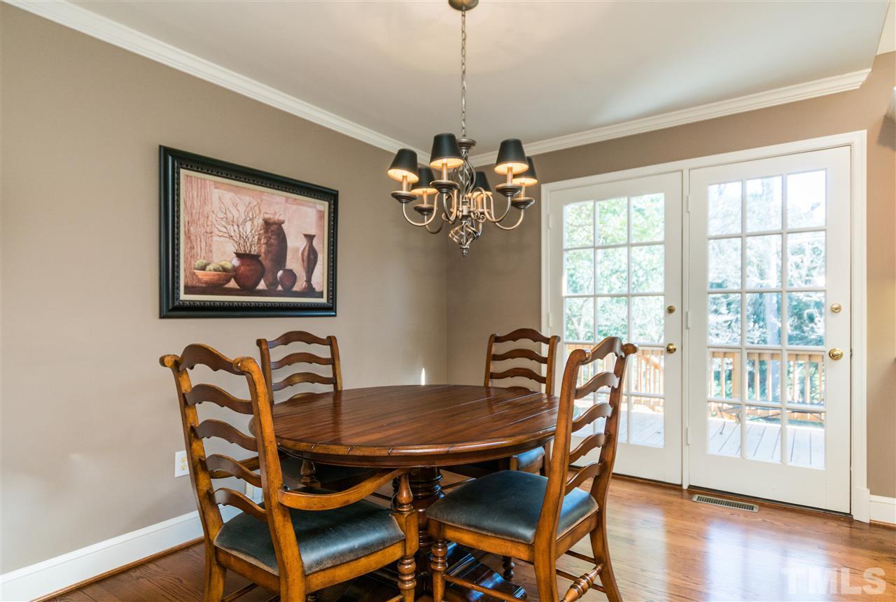1422 Canterbury Road Raleigh, NC 27608 - Photo 11 of 25 a view of a dining room with furniture wooden floor and chandelier