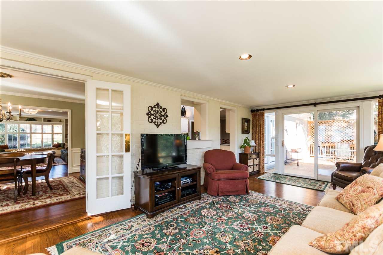 1422 Canterbury Road Raleigh, NC 27608 - Photo 13 of 25 a living room with furniture a rug and a flat screen tv