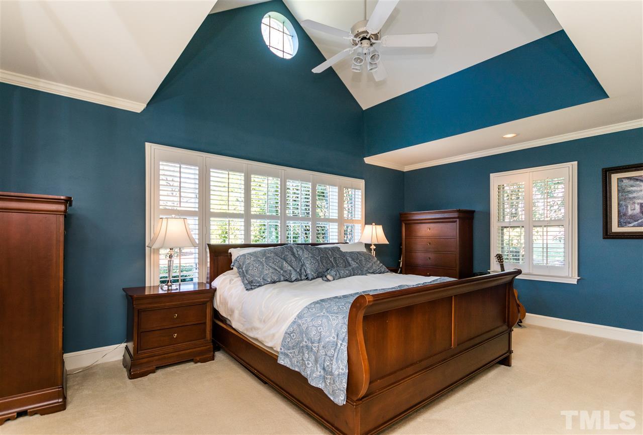 1422 Canterbury Road Raleigh, NC 27608 - Photo 15 of 25 a bedroom with a bed and a chandelier