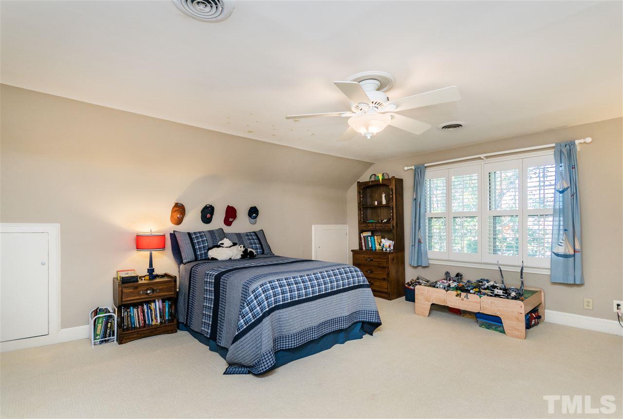 1422 Canterbury Road Raleigh, NC 27608 - Photo 20 of 25 a bedroom with a bed furniture and a large window