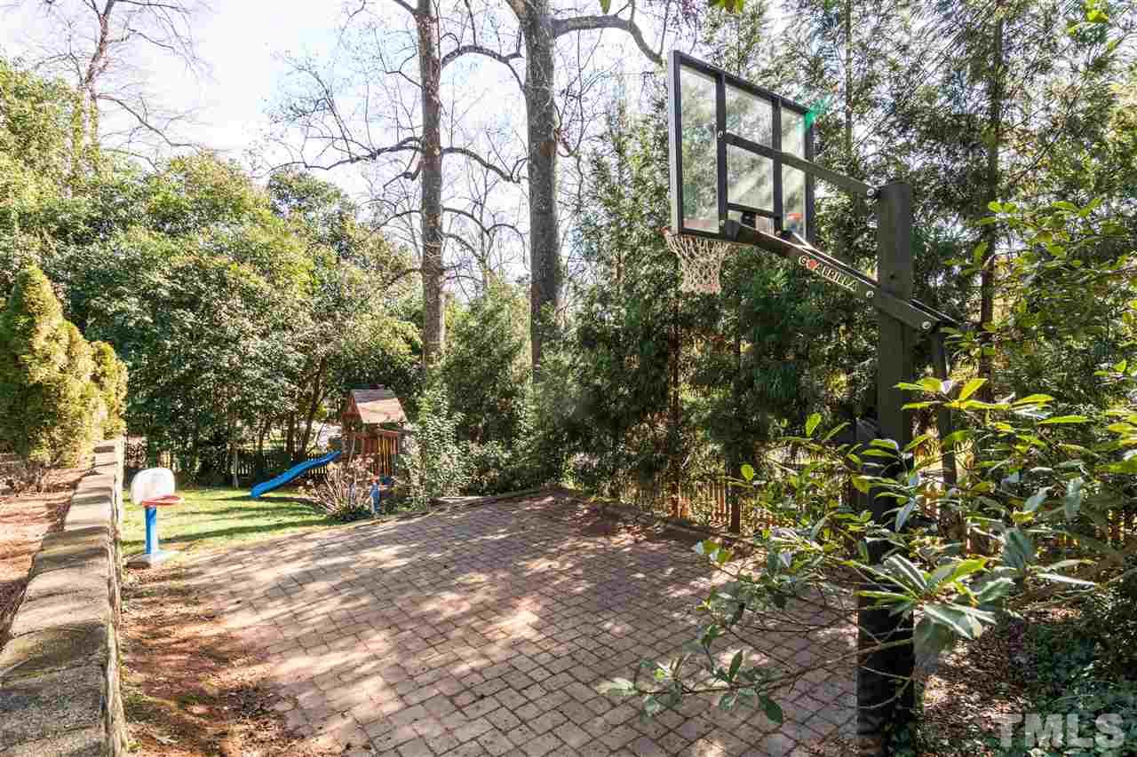 1422 Canterbury Road Raleigh, NC 27608 - Photo 24 of 25 a view of outdoor space with deck and trees