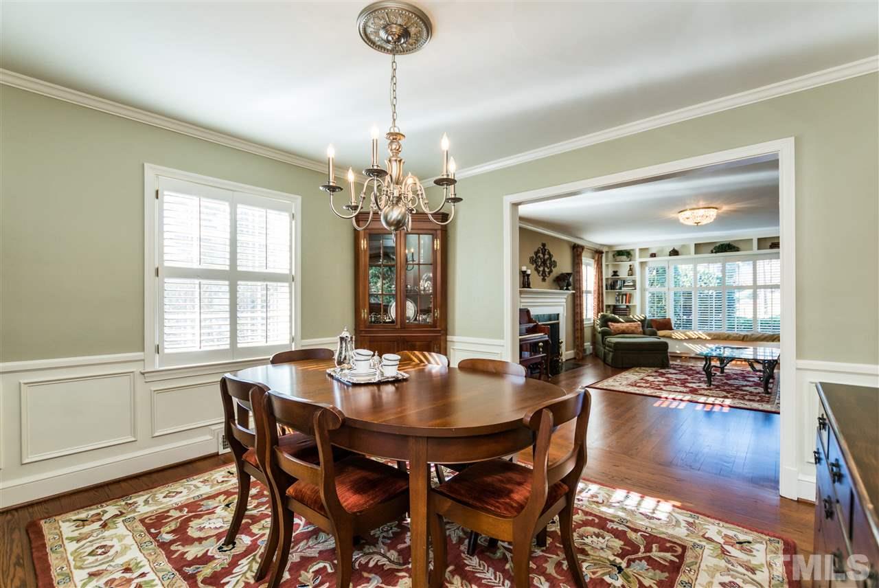 1422 Canterbury Road Raleigh, NC 27608 - Photo 6 of 25 a view of a dining room with furniture wooden floor and chandelier