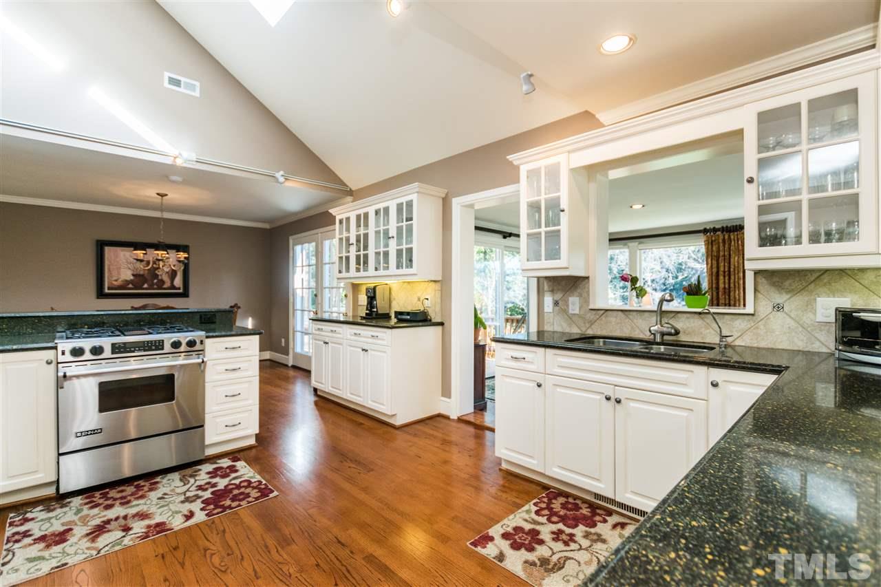 1422 Canterbury Road Raleigh, NC 27608 - Photo 7 of 25 a large kitchen with stainless steel appliances granite countertop a stove and a sink