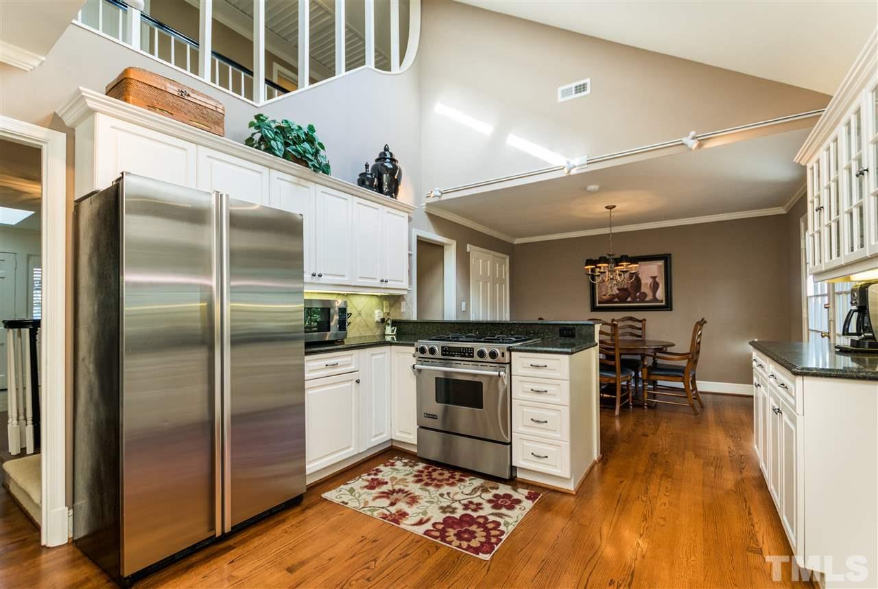 1422 Canterbury Road Raleigh, NC 27608 - Photo 8 of 25 a kitchen with stainless steel appliances granite countertop a refrigerator a stove and a sink