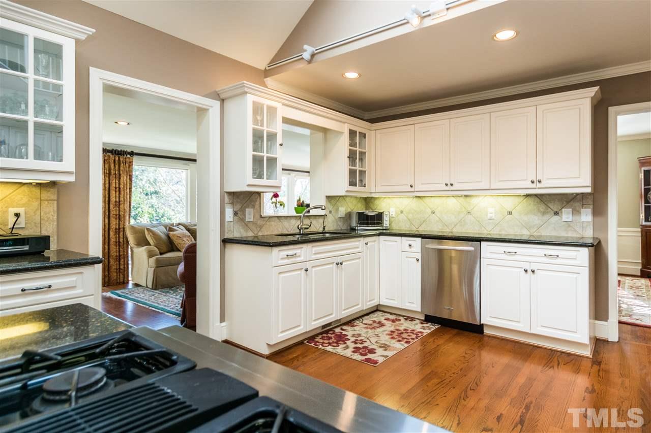 1422 Canterbury Road Raleigh, NC 27608 - Photo 9 of 25 a kitchen with a sink stove and cabinets